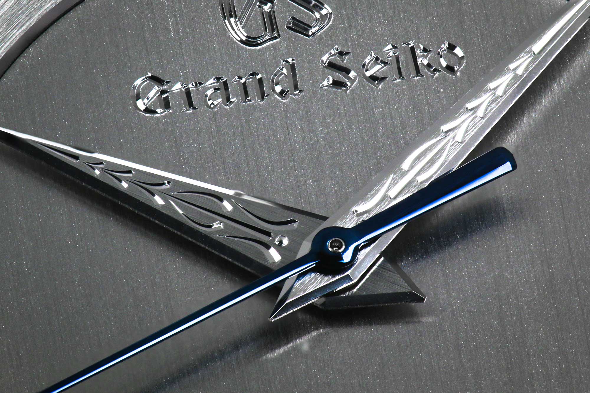 Grand Seiko SBGW263 macro of ornate engraved hands and logo.