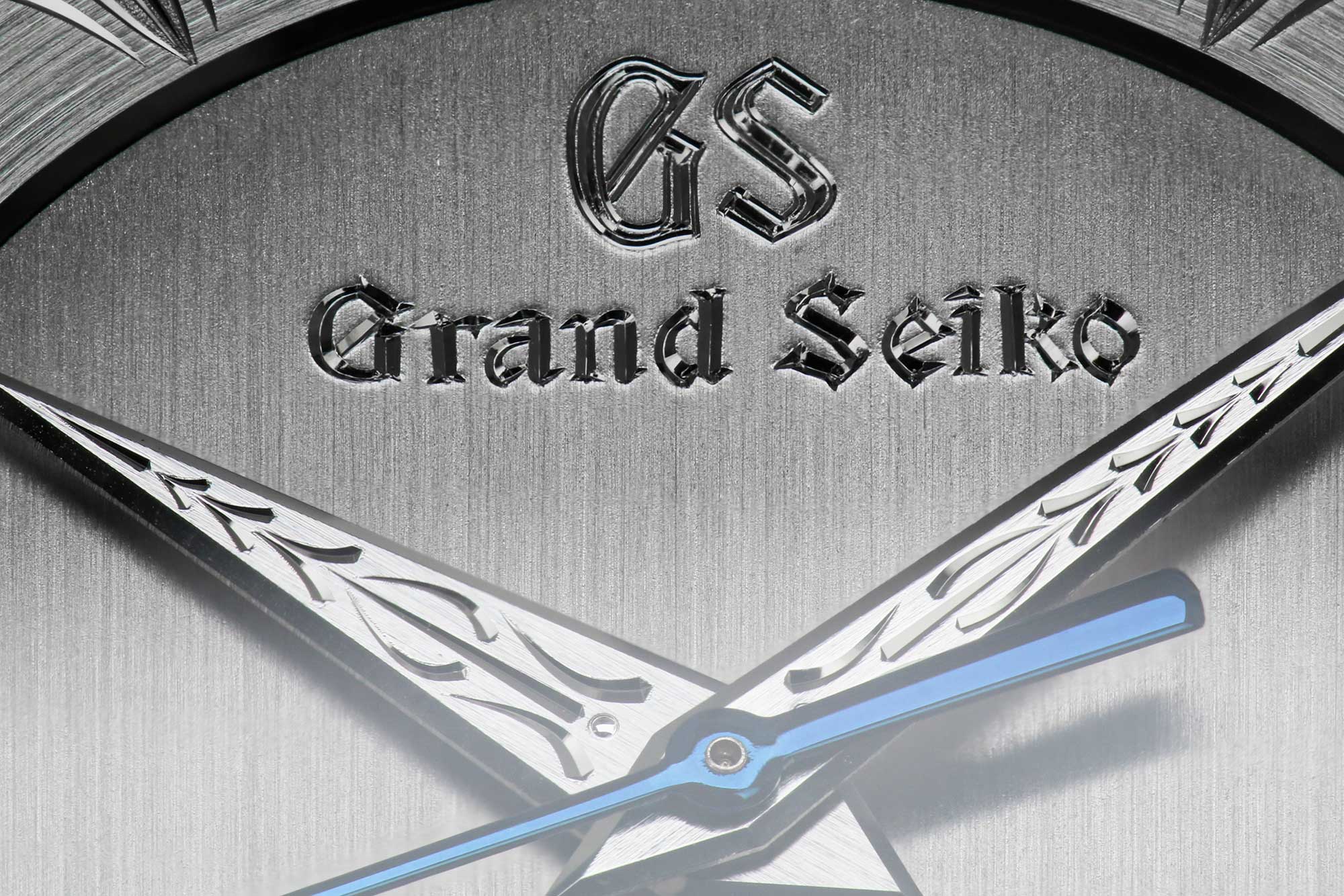 Grand Seiko SBGW263 macro of ornate engraved hands and logo.