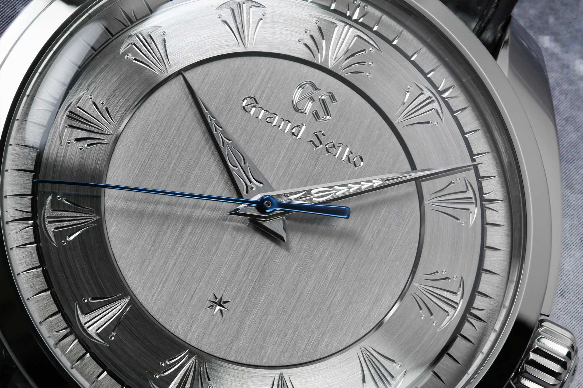 A closeup of the hand engraving work on the dial of Grand Seiko SBGW263.